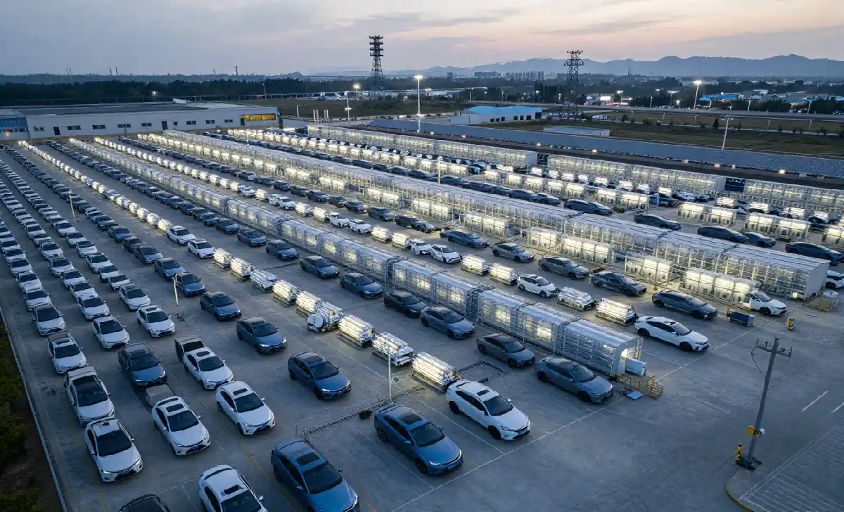 The Real Reason European Cars Are Losing the EV Race in 2026 Aerial view of a Chinese EV battery gigafactory with electric vehicles lined up for export in 2026