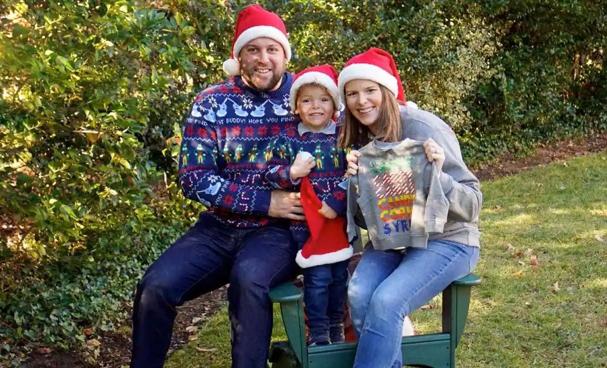 Matthew Mario Rivera and Kasie Hunt with son Mars in Santa hats announcing second baby in a People magazine exclusive Christmas photo
